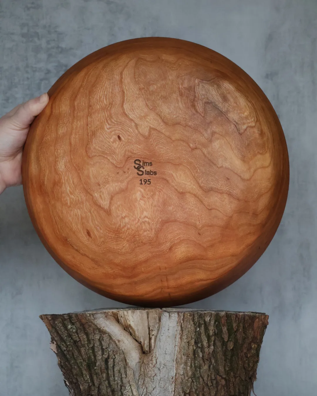 Bottom of hand-turned cherry bowl showing Sims Slabs maker's mark