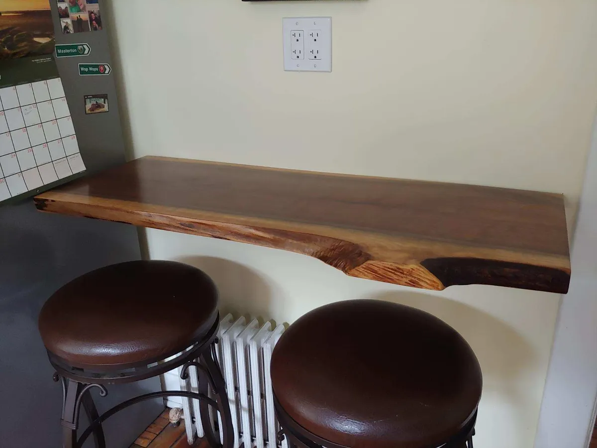 Wall-mounted live-edge walnut shelf bar