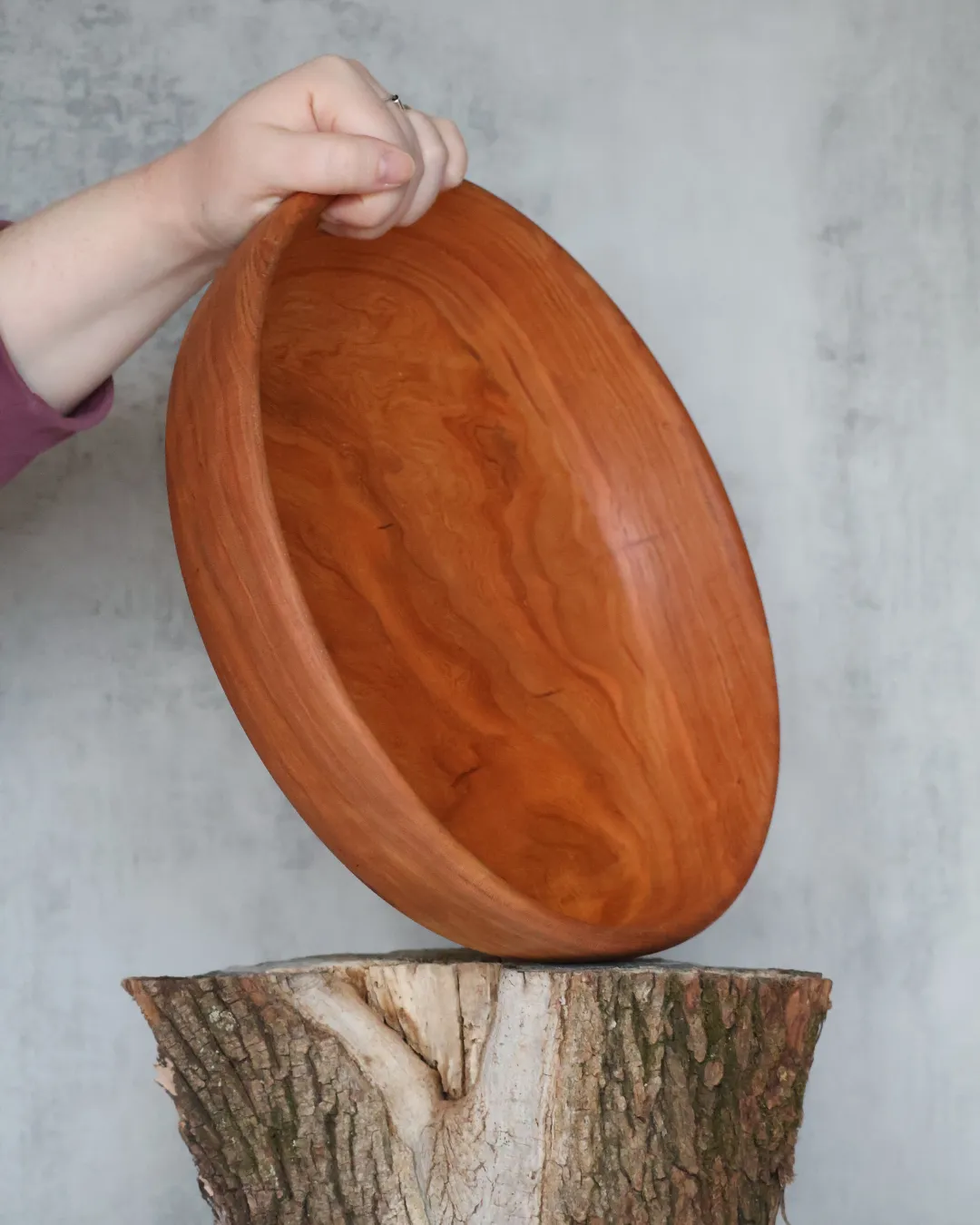 Small hand-turned burl wood bowl with dramatic two-tone grain on log stump