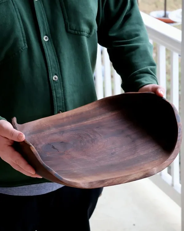 Hand-turned cherry wood platter tilted to show smooth interior finish