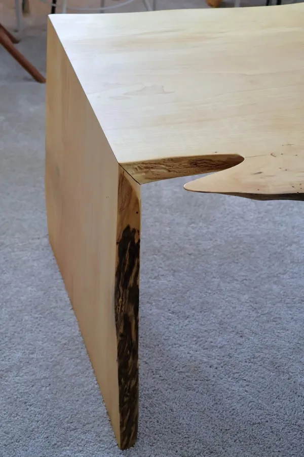Waterfall joint detail showing seamless wood grain on handmade maple table