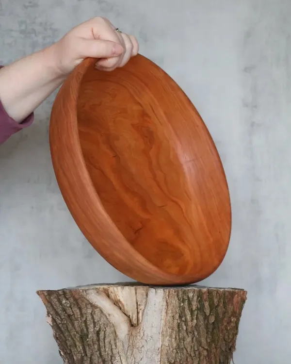 Small hand-turned burl wood bowl with dramatic two-tone grain on log stump