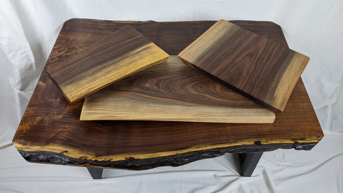 Handcrafted walnut cutting boards with natural sapwood gradient