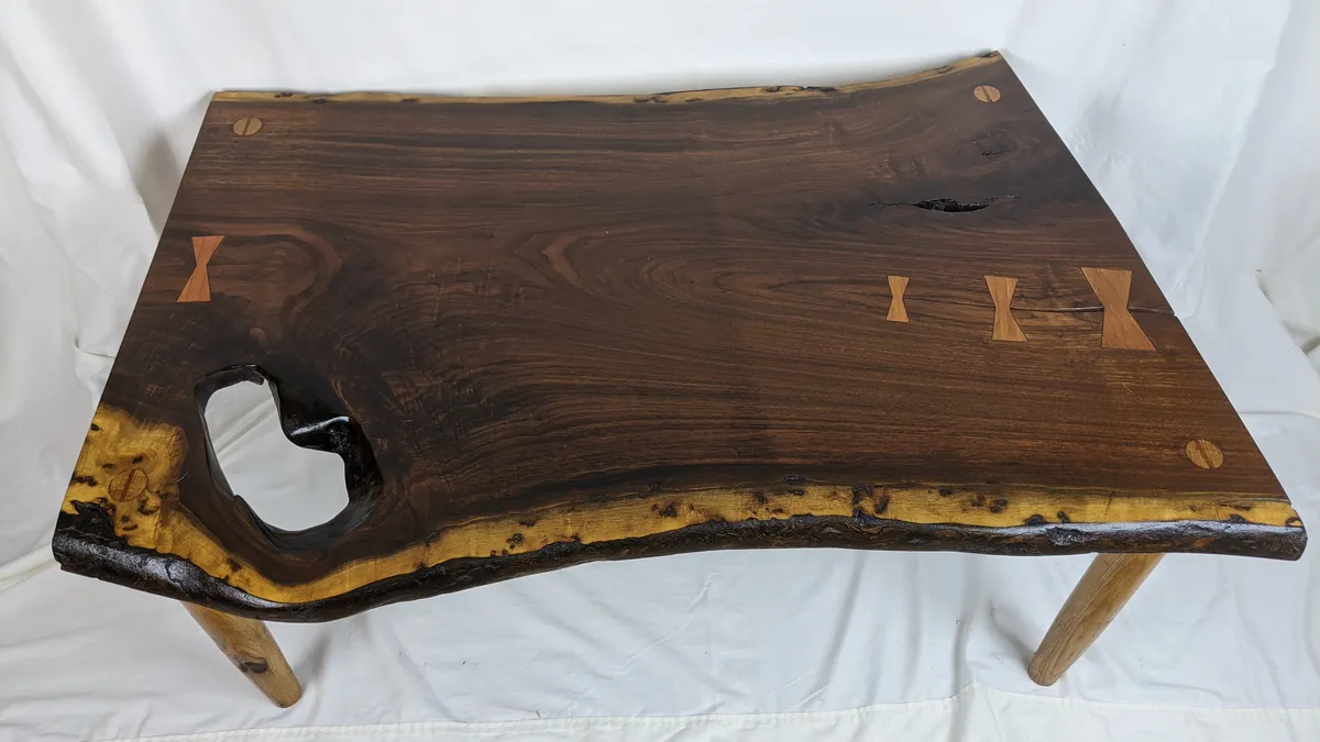Live-edge walnut table with butterfly inlays