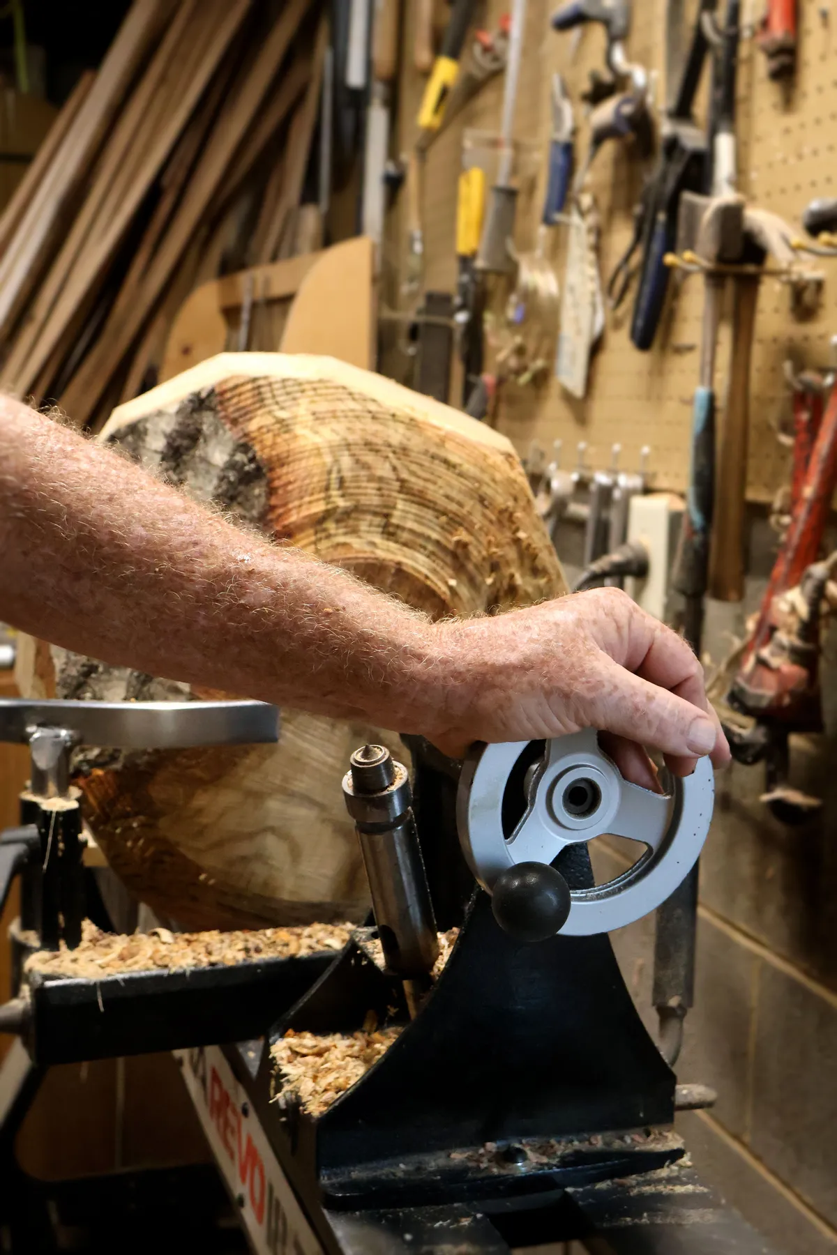 Woodworker adjusting lathe for bowl turning